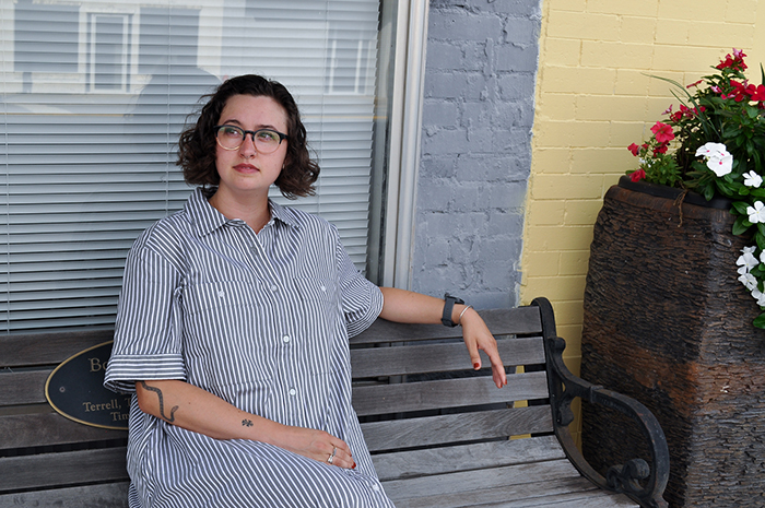 picture of Garrison Taylor, a graduate student in the UGA College of Environment and Design, sitting on a bench in downtown Baxley.