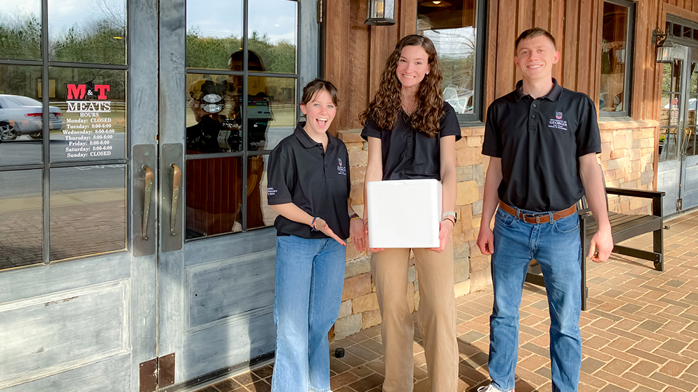 From left to right, PROPEL Rural Scholars Morgan White, Halle Bynum and Alex Crabb stopped by Mand;T Meats in Hawkinsville on a recent community visit. Photo by Sherié Raleigh.
