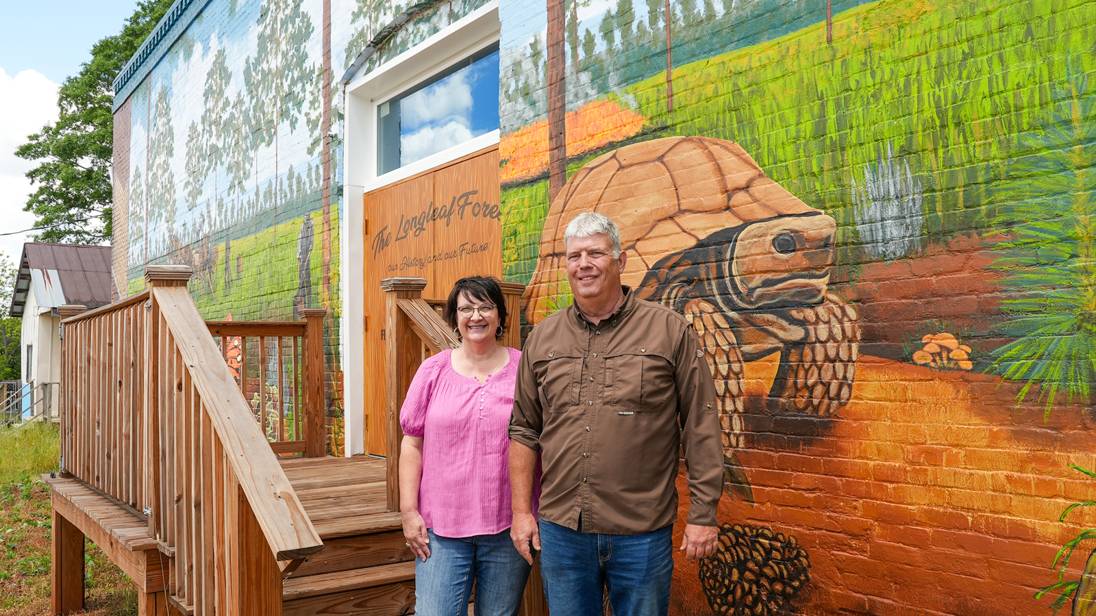 Jay and Faye Wells, longtime residents of the Buena Vista area, stand in front of the mural.