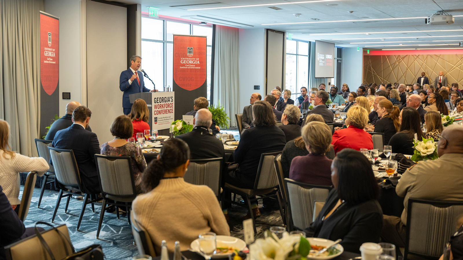 Gov. Brian Kemp speaks to a room of people during the closing luncheon for the Institute of Government Workforce Development Conference.