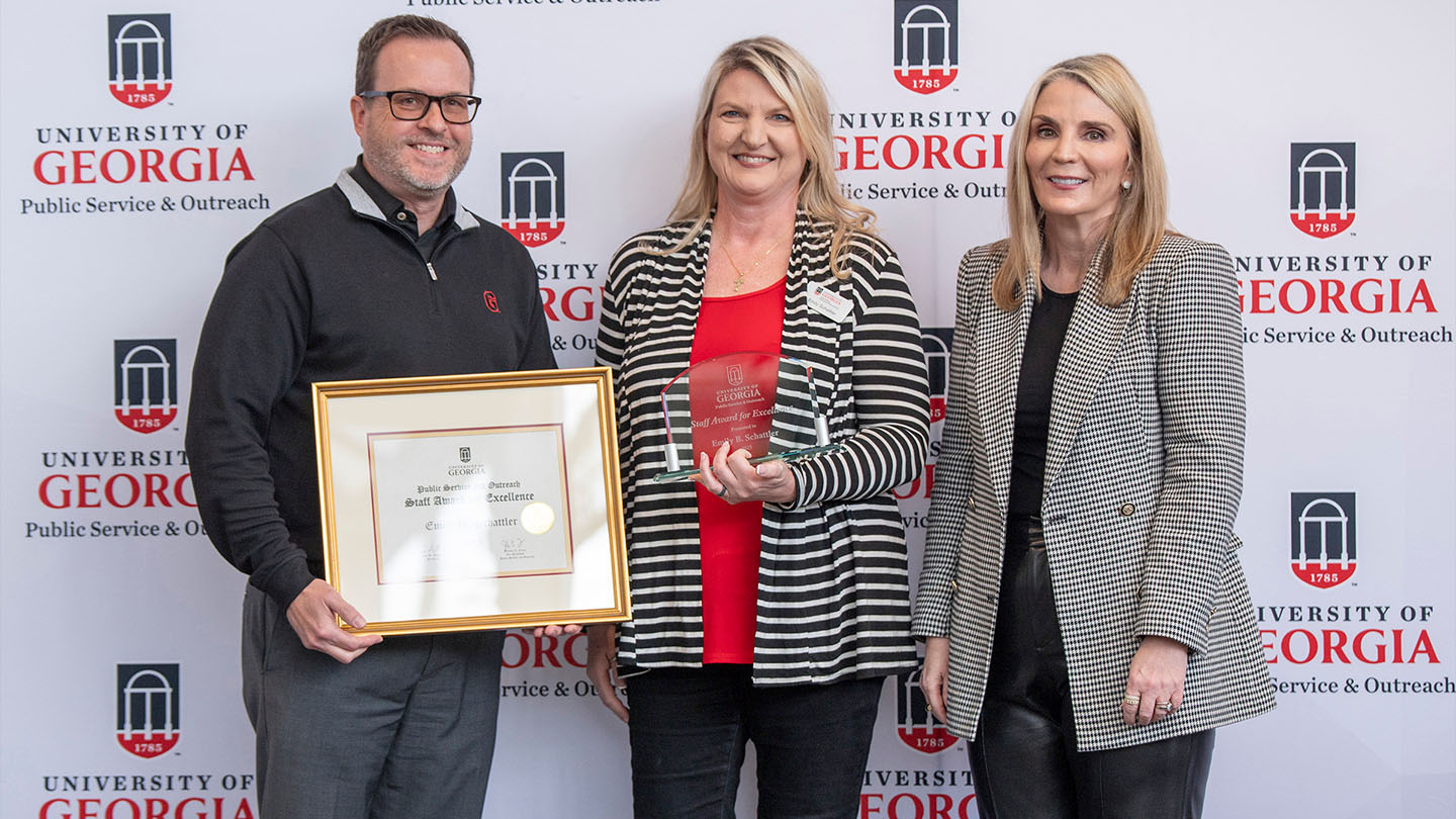 Emily Schattler (center), received the PSO Staff Award for Excellence at the PSO Fall Appreciation Event. Pictured with Institute of Government Director Rob Gordon (left) and Vice President for Public Service and Outreach Jennifer Frum (right). 