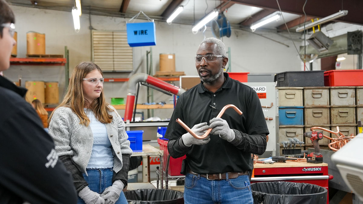 UGA PROPEL Rural Scholars Chase Walker, left, and Robie Lucas listen to Production Manager James Hugley at Marvair in Cordele.