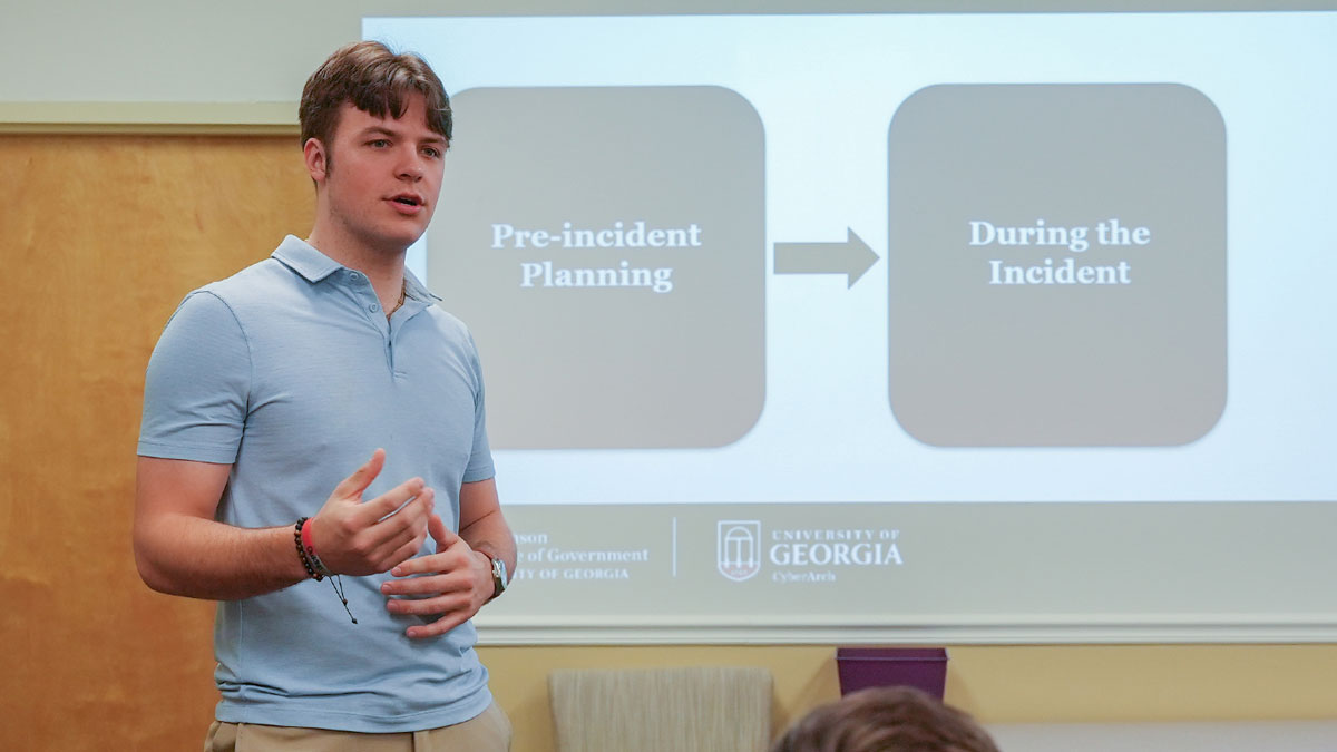 picture of Deven Allen standing in front of a presentation screen