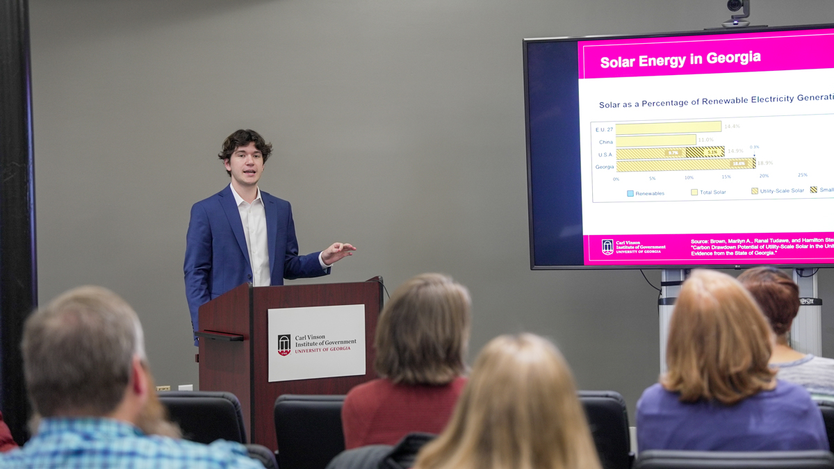 UGA student and Vinson Fellow Alex Drahos discusses his research on the state of solar farms in Georgia at the UGA Institute of Government. (Photo by Sara Ingram)