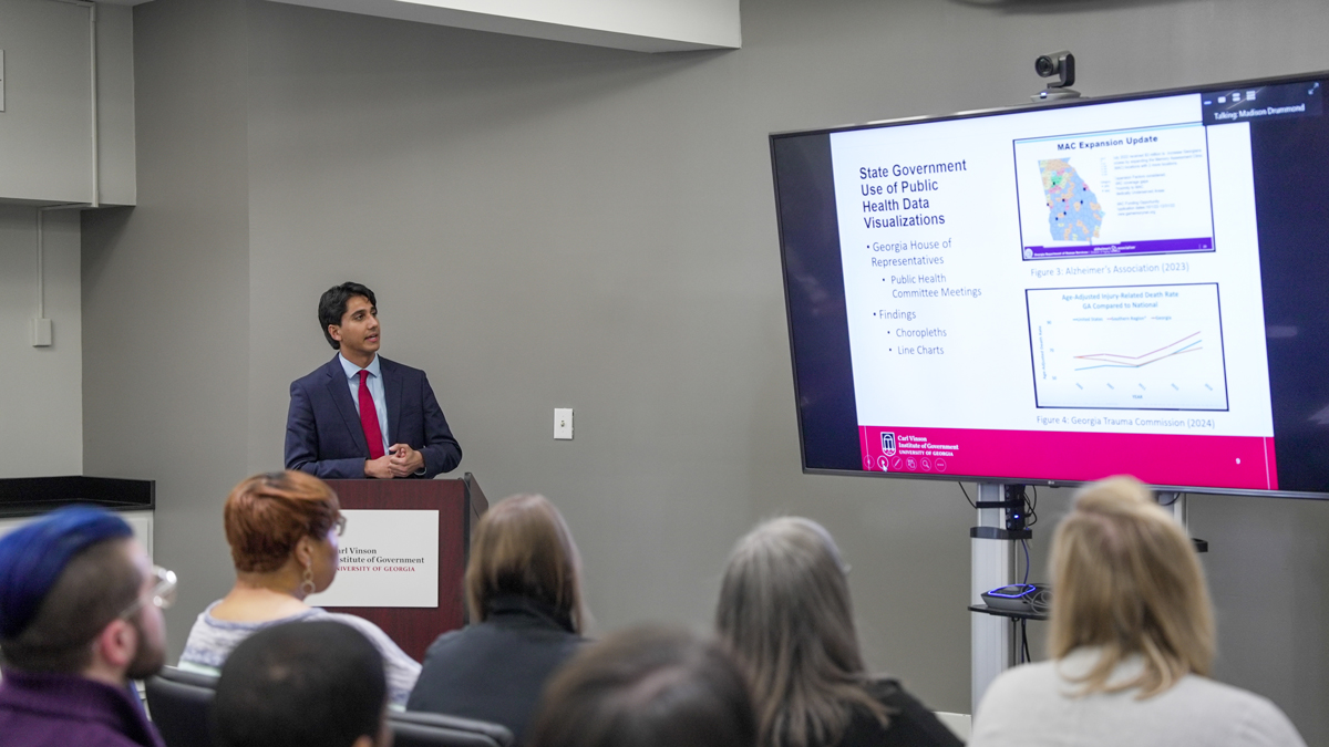 UGA student and Vinson Fellow Aarov Malhotra presents his research on Georgia public health data at the UGA Institute of Government. (Photo by Sara Ingram)