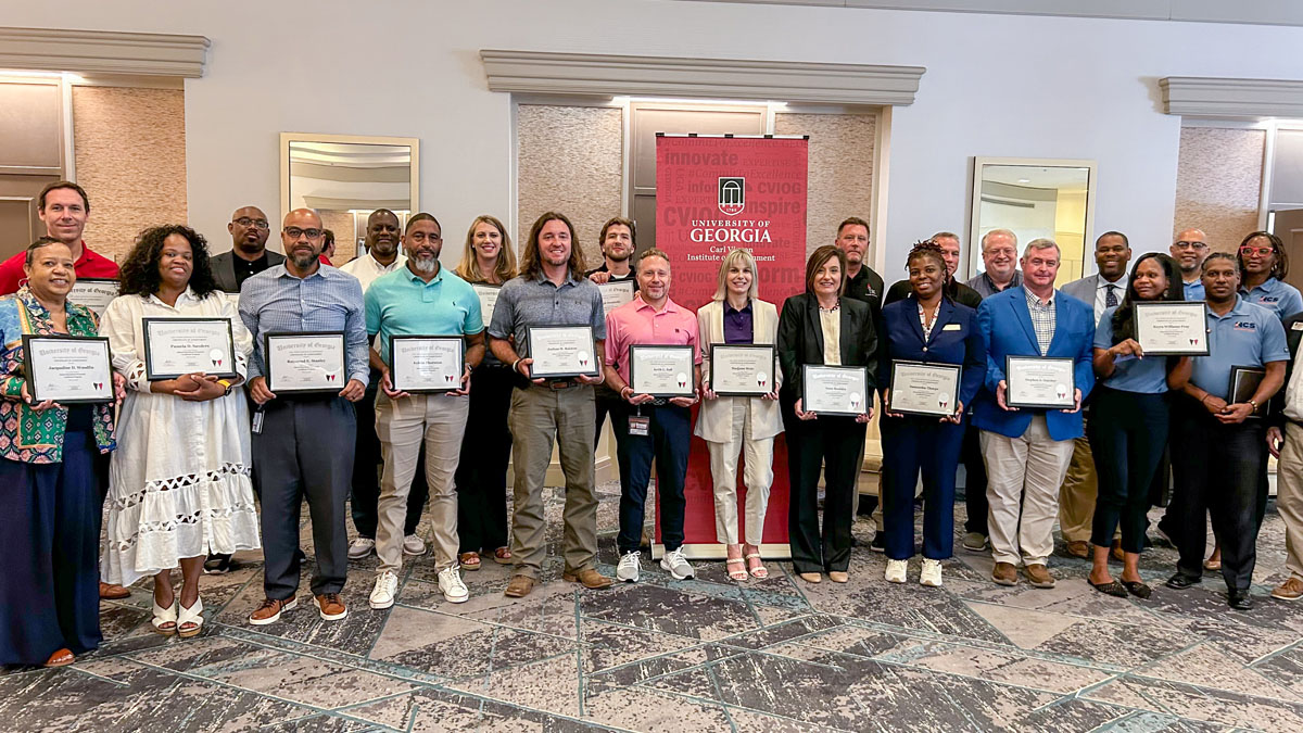 group of graduates standing with their certificates