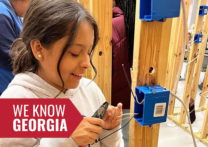 Student participating in “This Girl Can” program practices wiring a light switch as part of non-traditional occupational training.