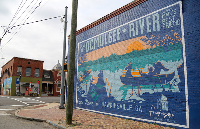 A mural in downtown Hawkinsville reflects the community tagline “Come Home to Hawkinsville,” which was developed through the UGA Vinson Institute of Government’s community branding services. Many historic buildings in Hawkinsville are seeing renovations for the first time in decades thanks to collaborations with UGA faculty and students. 