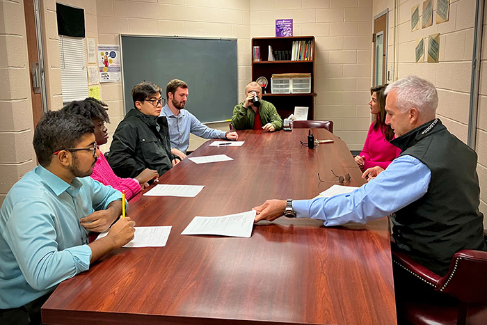 Mark Lupo, program coordinator for UGA CyberArch, and students meet at a client site to review needs and develop a plan. (photo by Shannah Montgomery)